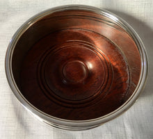 Asprey, Elizabeth II, silver wine coaster with turned wood base. Birmingham 1994 Asprey plc.