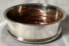 Asprey, Elizabeth II, silver wine coaster with turned wood base. Birmingham 1994 Asprey plc.