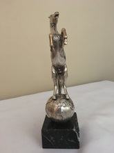 Beautifully cast silver plated rearing horse atop a silver plated globe.