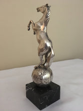 Beautifully cast silver plated rearing horse atop a silver plated globe.