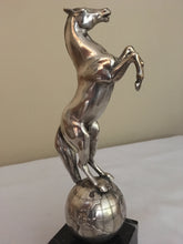 Beautifully cast silver plated rearing horse atop a silver plated globe.