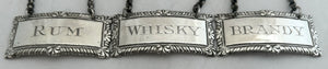 George V Whisky, Brandy & Rum Silver Decanter Labels. London 1933 D & J Wellby Ltd.