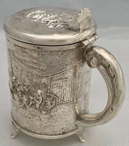 A Northern European Style Silver Plated Lidded Tankard with Relief Detail.