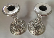 Elkington late Victorian pair of high relief classical scene silver plated candlesticks. Dated 1896.