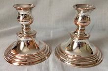 Early 20th century pair of silver plate on copper twin branch three light candelabra, converting to candlesticks.