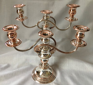 Early 20th century pair of silver plate on copper twin branch three light candelabra, converting to candlesticks.