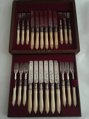 George V, walnut cased 12 person canteen of cutlery with carved ivory handles and silver ferrules. Sheffield 1923 William Hutton & Sons