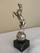 Beautifully cast silver plated rearing horse atop a silver plated globe.